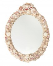 AN OVAL SHELL WALL MIRRORAn ov