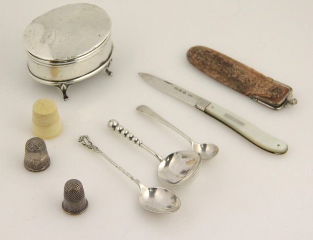 An oval silver trinket box