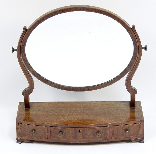 An oval swing-frame toilet mirror