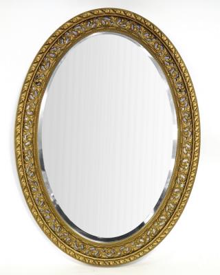 An oval wall mirror in decorative