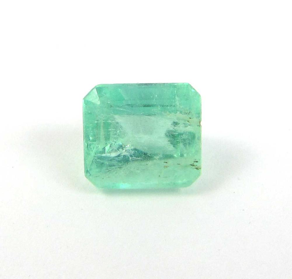 AN UNSET GREEN COLOMBIAN EMERALD
