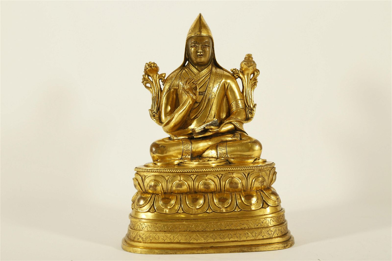 AN UNUSUAL GILT-BRONZE FIGURE OF