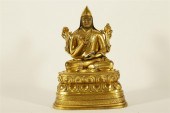 AN UNUSUAL GILT-BRONZE FIGURE