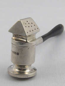 An unusual silver pepperette in a