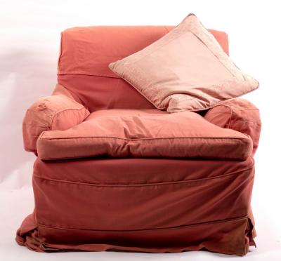 An upholstered armchair fitted a