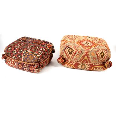 An upholstered foot stool covered
