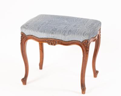 An upholstered footstool on