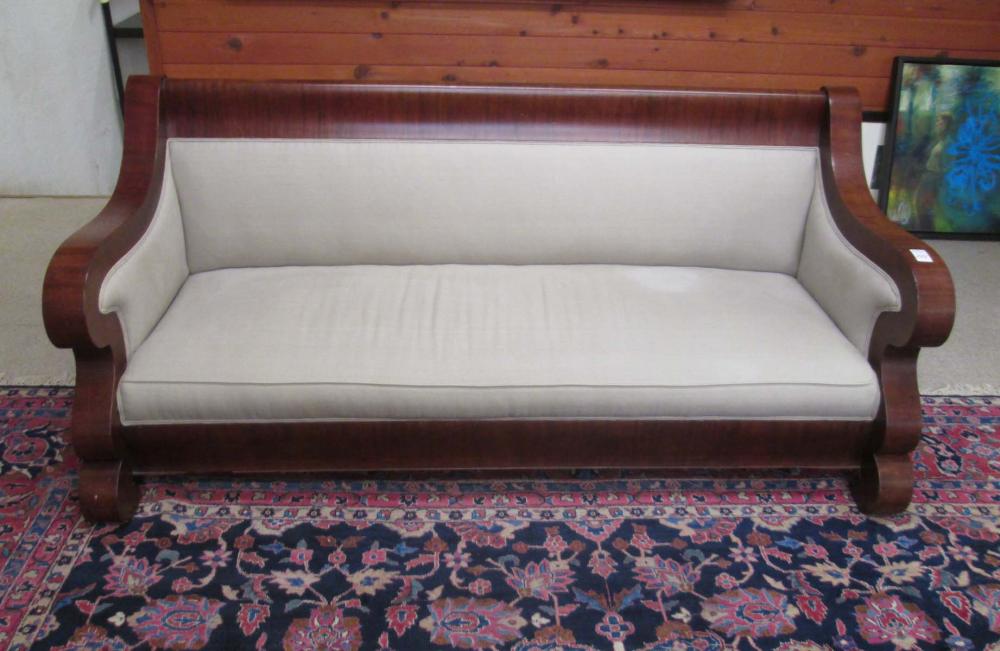 AN UPHOLSTERED MAHOGANY SOFA,