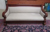 AN UPHOLSTERED MAHOGANY SOFA,