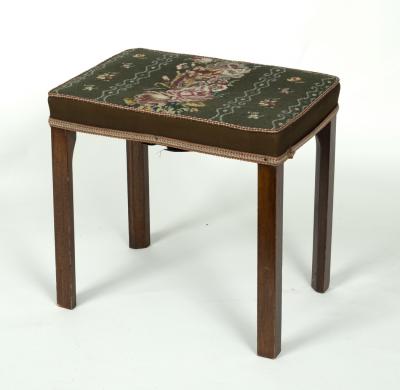 An upholstered stool on square