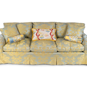 An Upholstered Three Cushion Sofa