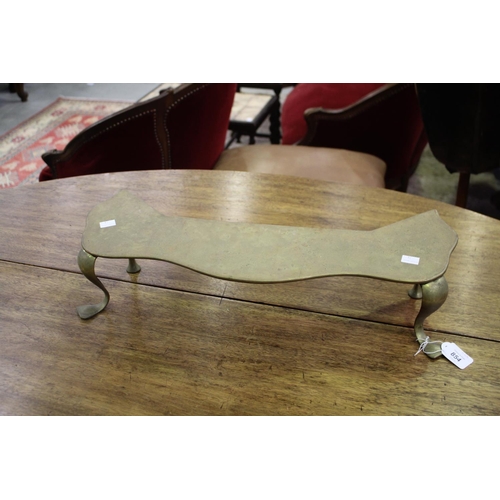 Antique brass and iron trivet on