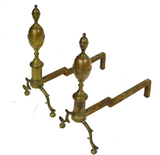 Antique brass andirons with lemon