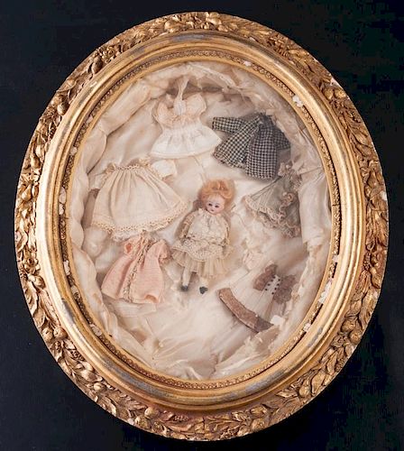 ANTIQUE DOLL AND SEVEN DRESSES IN