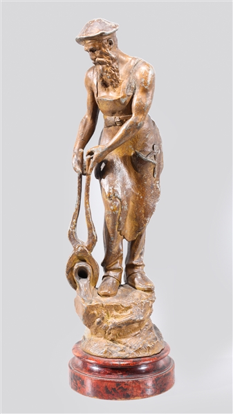 Antique metal statue of a forge