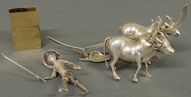 Asian silver man with plow and oxen