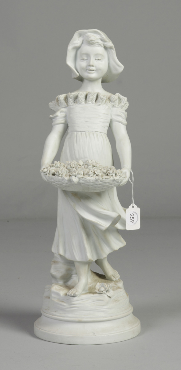 Bisque Figure of a girl w/flower