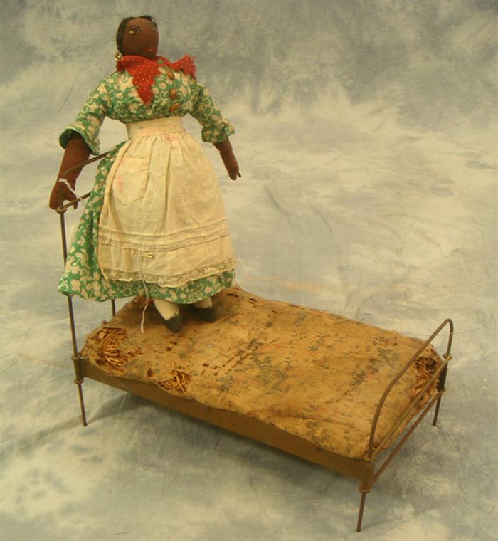 Black cloth doll and iron doll bed