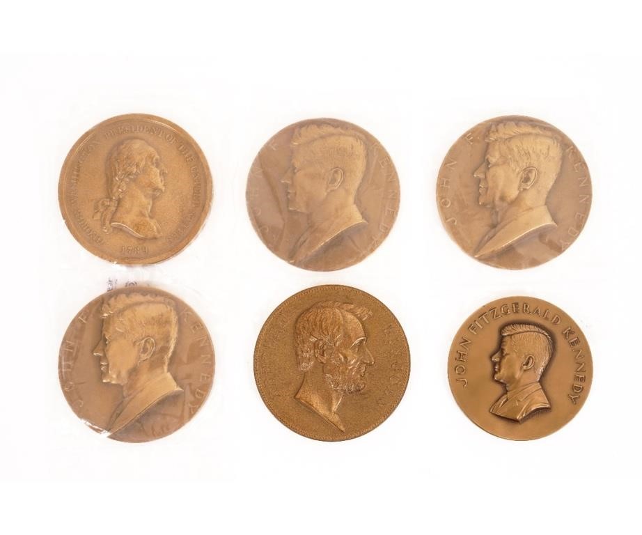Boxed round bronze medals of former