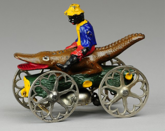 BOY RIDING ALLIGATOR BELL TOY