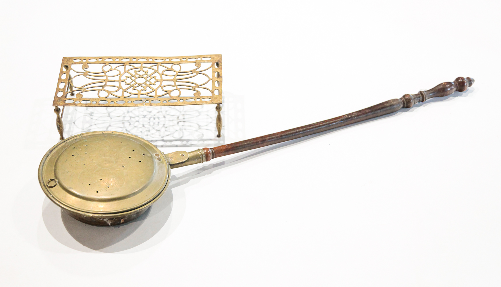 BRASS BEDWARMER AND TRIVET. Late