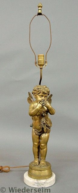 Brass putti lamp mounted on a