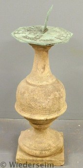 Brass sundial with a cast ston