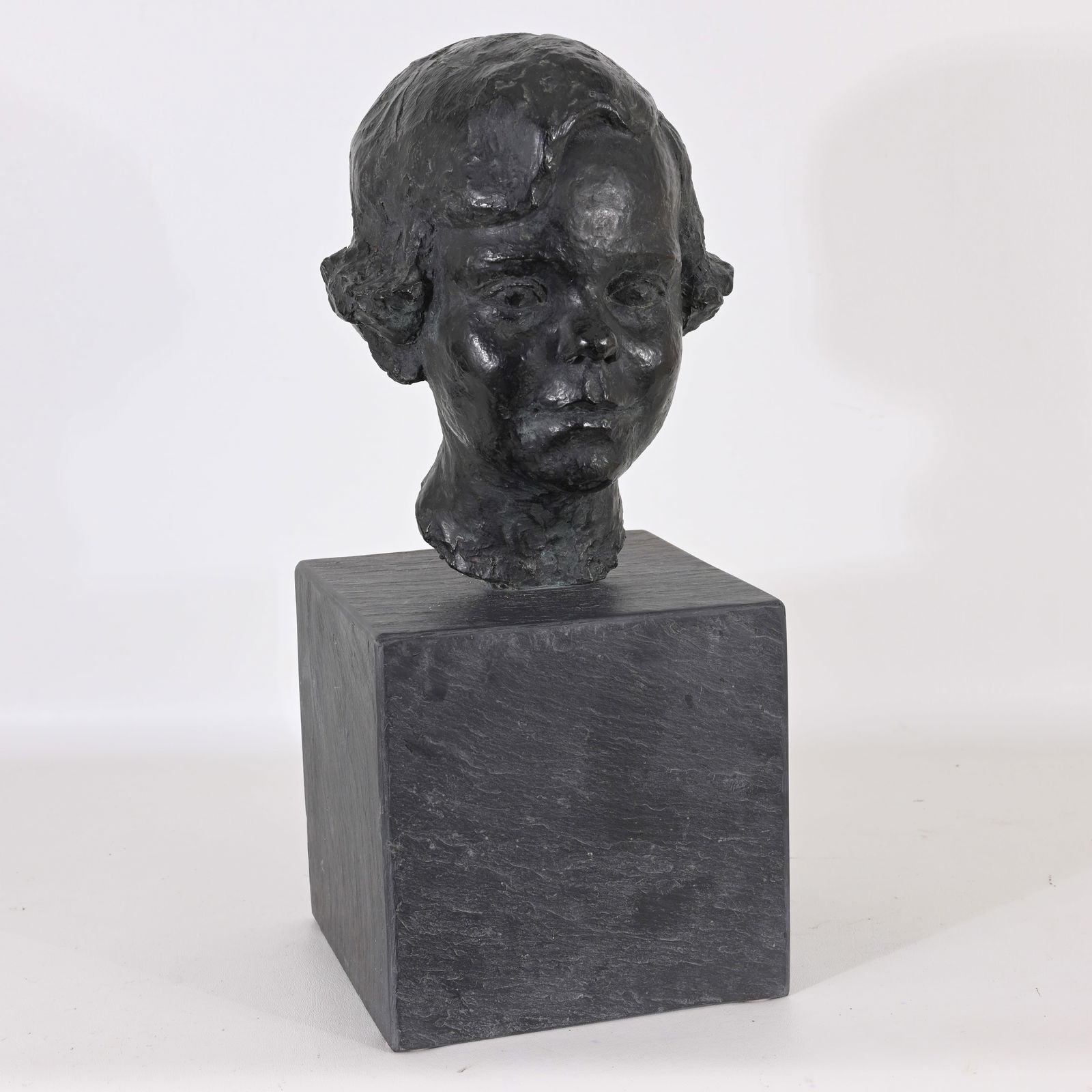 BRONZE BUST OF A GIRL ON PLINTH