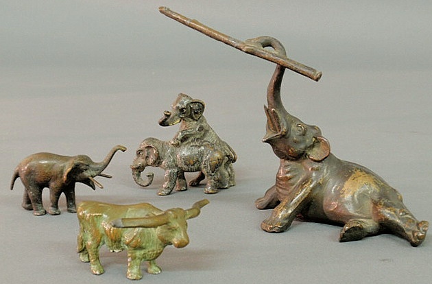 Bronze elephant holding a tree