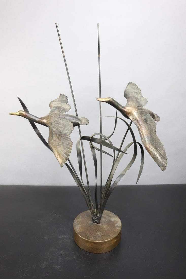 BRONZE GEESE FLYING ABOVE