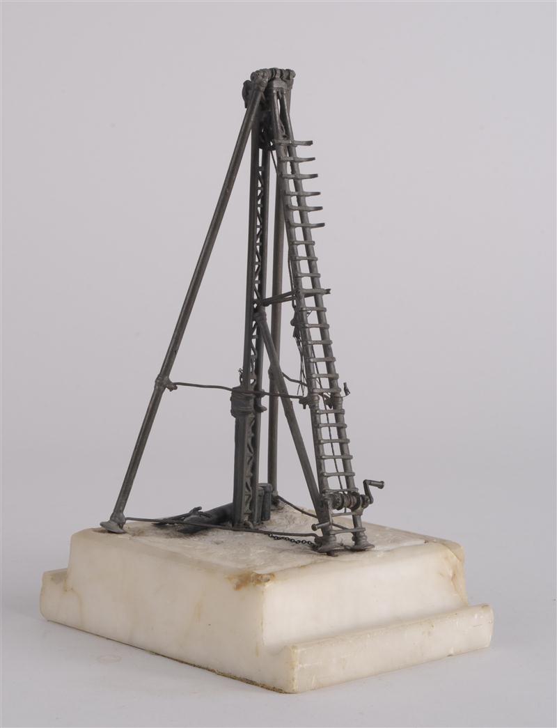 BRONZE MODEL OF A DRILL RIG The