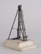 BRONZE MODEL OF A DRILL RIG Th