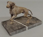 Bronze of a hunting dog on poi