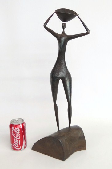 Bronze of a woman marked