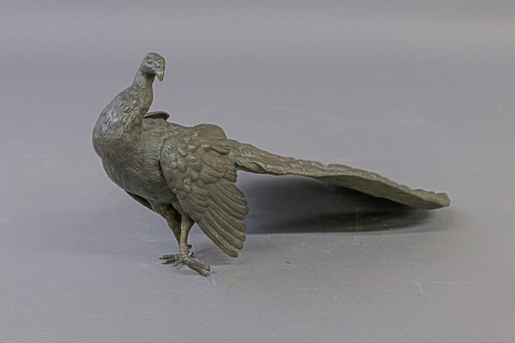 Bronze peacock with spread tail