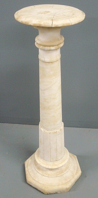 Carved alabaster pedestal with a