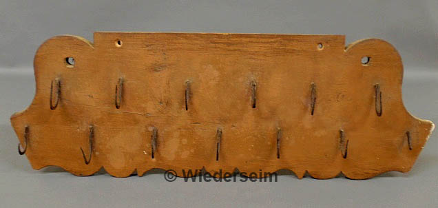 Carved and painted hanging rack
