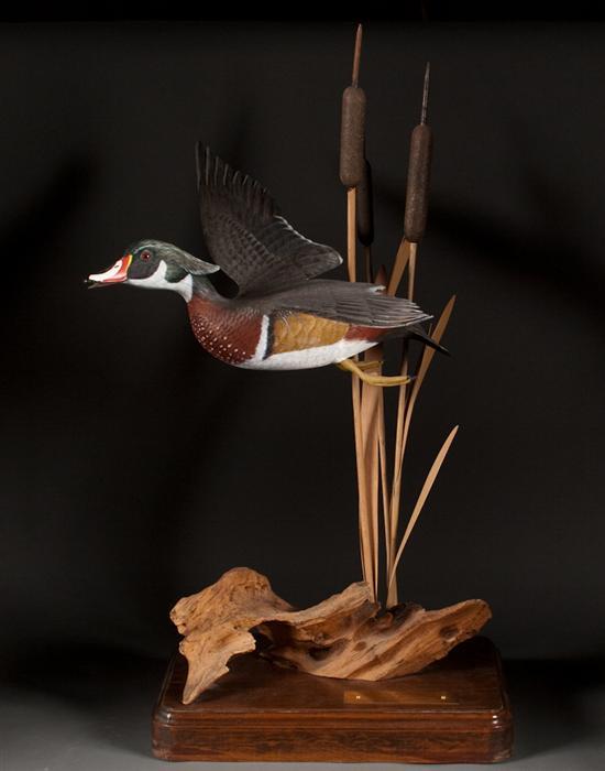 Carved and polychromed wood duck in