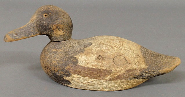 Carved duck decoy with glass