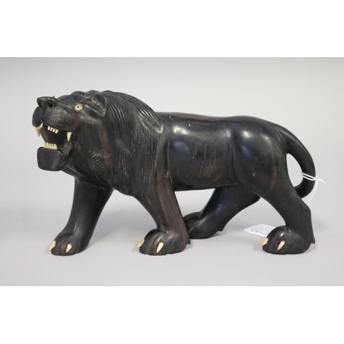 Carved hardwood lion figure,