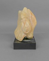 Carved head of a woman signed