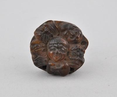 Carved Horn Netsuke of Many Faces