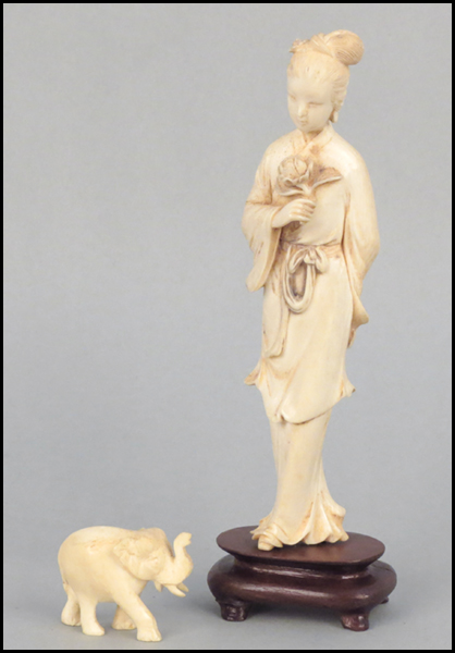 CARVED IVORY FIGURE HOLDING A