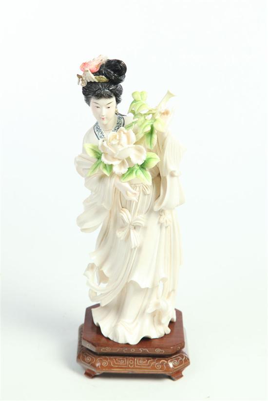 ***CARVED IVORY FIGURE OF A WOMAN.