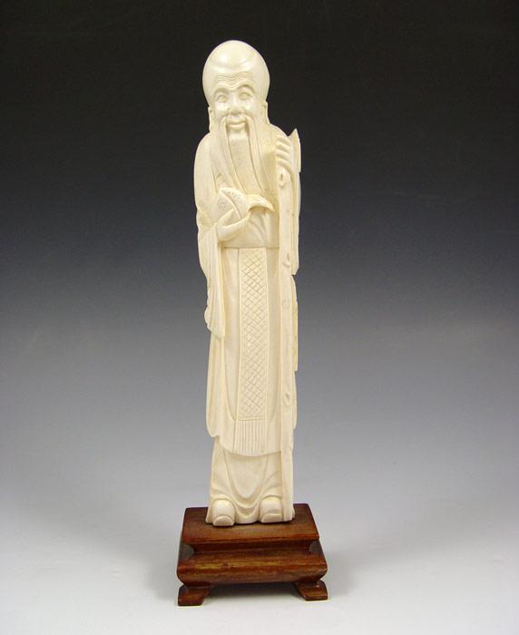 CARVED IVORY FIGURE OF AN ELDER: