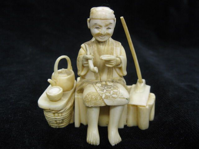 Carved Ivory Figurine seated man at