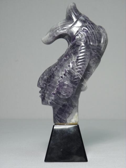 Carved natural amethyst tribal head