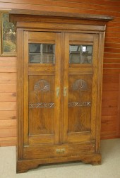 CARVED OAK AND BEVELED GLASS W