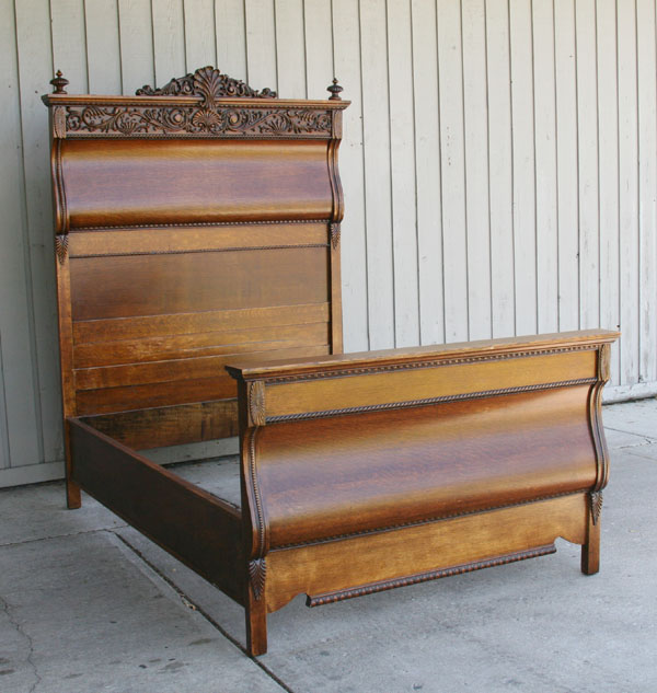 Carved oak high back bed; floral