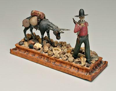 Carved prospector, mule, walking